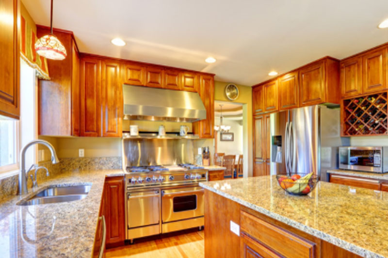Quartz countertops with honey oak cabinet