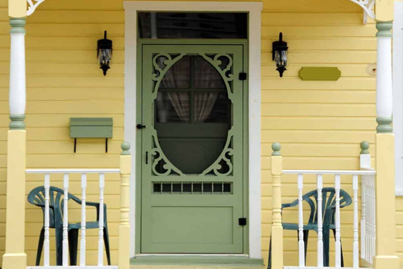 Sage green door with yellow home