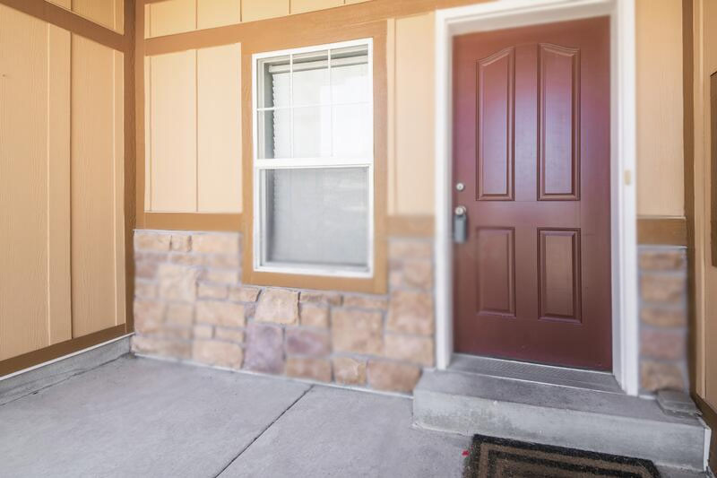 Burgundy front door for beige house