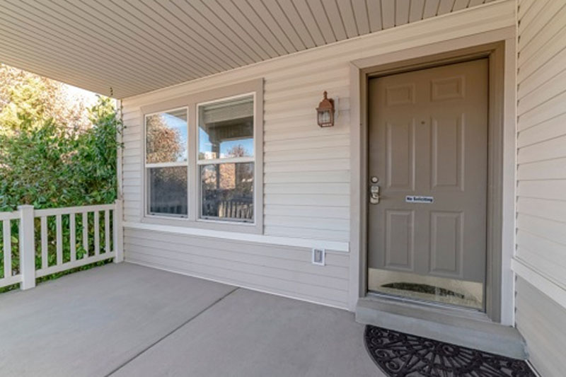 Wooden front door for beige house